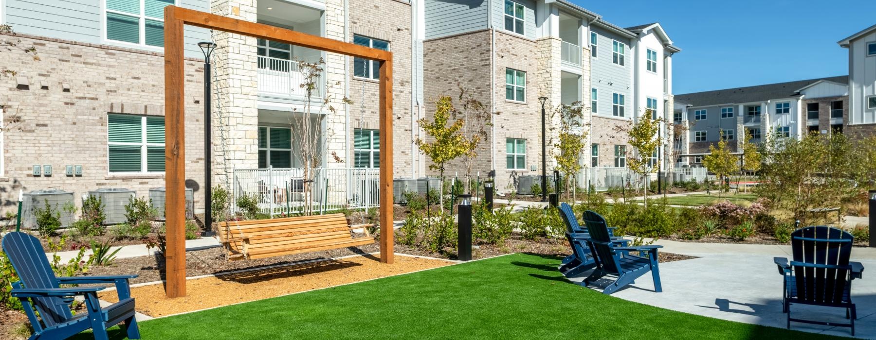 a building with a lawn and chairs