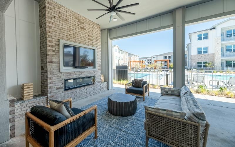 a living room with a fireplace and a view of the city