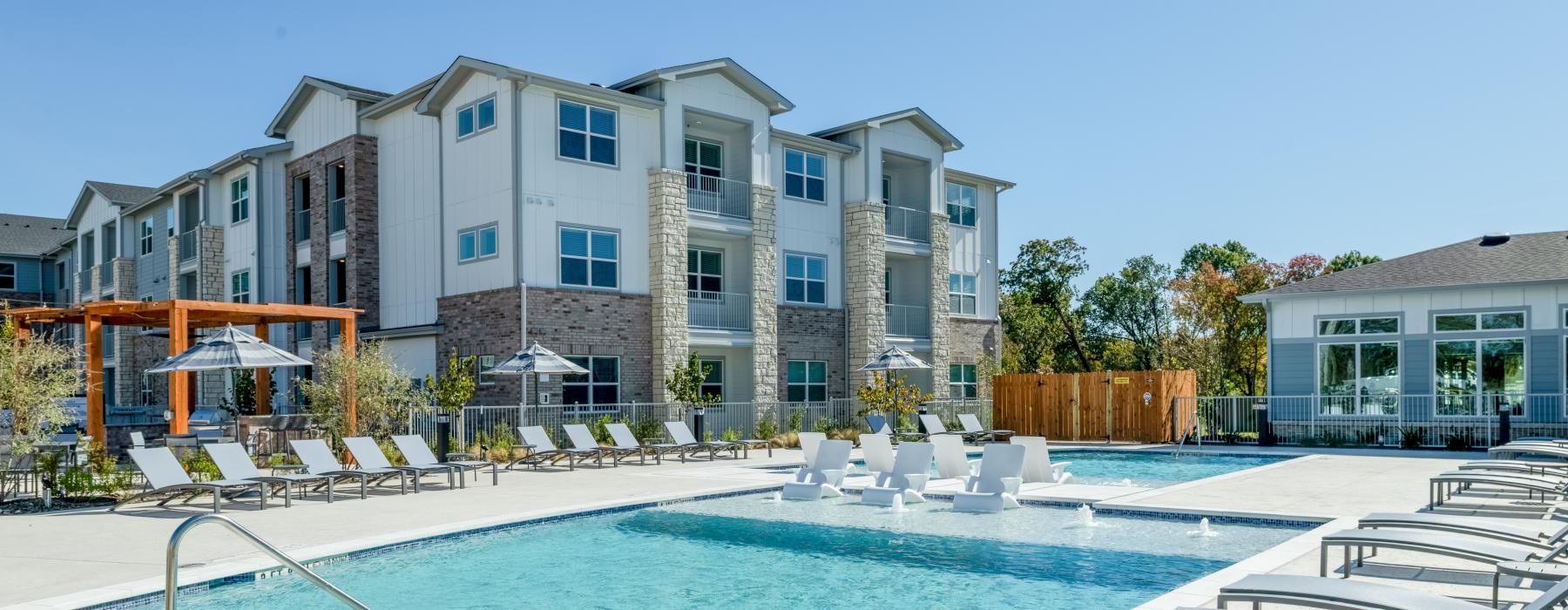 pool showing reclining seating and nearness to property buildings