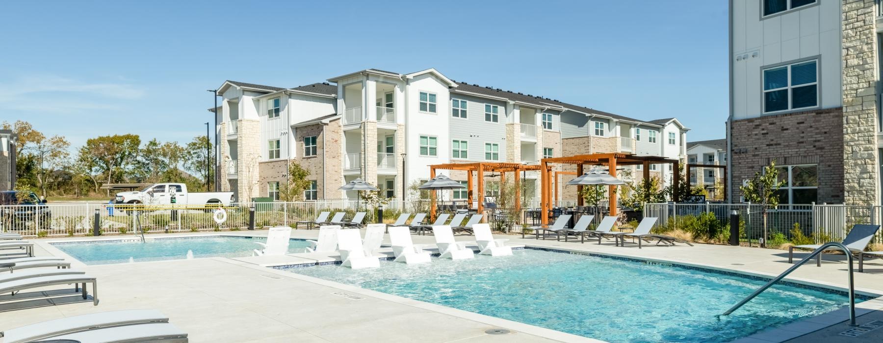 a swimming pool in front of a large building