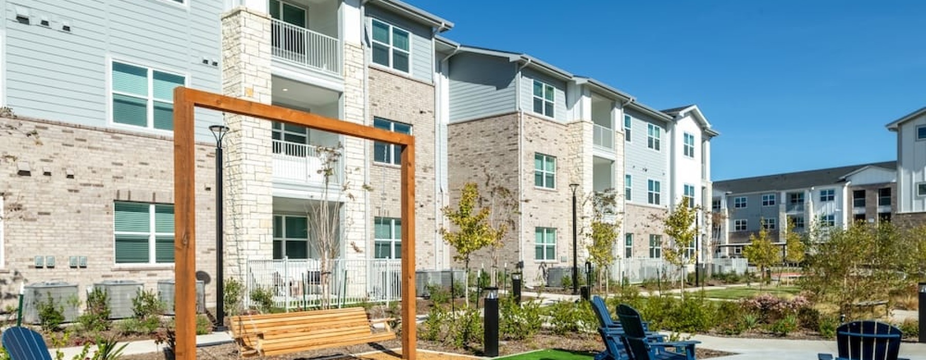 a building with a lawn and chairs